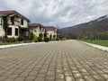 Close up of residential buildings in mountainous terrain. Cottage houses in countryside in cloudy weather.