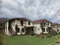 Close up of residential buildings in mountainous terrain. Cottage houses in countryside in cloudy weather.