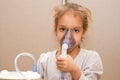 Close up. Respiratory diseases. A 5-year-old child inhales medication using a nebulizer. Therapy of coronavirus Royalty Free Stock Photo