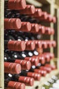Close up of resting wine bottles stacked on wooden racks
