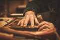 Close-up of restorer hands working with antique decor element in his workshop Royalty Free Stock Photo