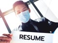 Close-up of resume paper in hand of Asian businessman