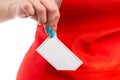 Close-up of retail employee putting business card in pocket