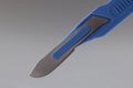 Retractable pocket sized box cutter, sharp instrument in blue colour knife Royalty Free Stock Photo
