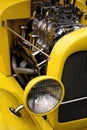 Retro Headlight and Engine on a Yellow Vintage Car