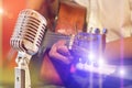 Close up retro microphone with musician playing acoustic guitar on band Royalty Free Stock Photo