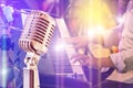 Close up retro microphone with musician playing keyboard synthesizer on band Royalty Free Stock Photo