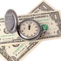 Close-up of a retro pocket watch on two bills of one US dollar. The arrows indicate midday or midnight. The concept on the time Royalty Free Stock Photo