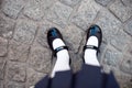 Close-up retro style image of school girl`s feet in uniform