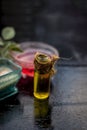 Close up of rice flour face pack on wooden surface in a blue colored glass bowl with some raw rose water,rice flour and Castor oil Royalty Free Stock Photo