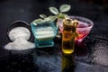 Close up of rice flour face pack on wooden surface in a blue colored glass bowl with some raw rose water,rice flour and Castor oil Royalty Free Stock Photo