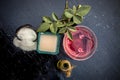 Close up of rice flour face pack on wooden surface in a blue colored glass bowl with some raw rose water,rice flour and Castor oil Royalty Free Stock Photo