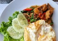 Close-up of the rice topped with stir-fried crispy pork (belly) with Thai basil and a fried egg Royalty Free Stock Photo
