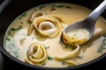 close-up of rich, creamy broth with slow swirls