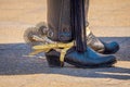 Close up of riding spurs with sharp spikes rowel on authentic western cowboy traditional leather boots on old aged in a Royalty Free Stock Photo
