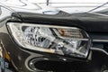 Close-up of right headlight of dark gray Renault Sandero Stepway car at Renault Royalty Free Stock Photo