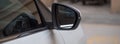 A partial close-up of the right side mirror of a white Citroen C5 aircross SUV