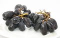 Close up, ripe bunch of black grapes with shining drop of water isolated on white background Royalty Free Stock Photo