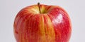 Close up of a ripe red and yellow apple with a stem against a plain light background with the use of an AI. Royalty Free Stock Photo