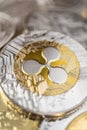 Close-up of ripple physical coin on stack of many other cryptocurrencies