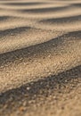 Close-up of rippled sand patterns created by wind or water, displaying a series of Royalty Free Stock Photo