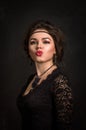 Close up. Roaring Twenties. Woman portrait in the style of Gatsby. Low key. Beautiful young woman in a black lace dress. Royalty Free Stock Photo