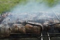 close-up: roast porkmeat inside grill on fire with smoke