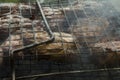 close-up: roast porkmeat inside grill on fire with smoke Royalty Free Stock Photo