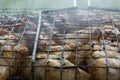 close-up: roast porkmeat inside grill on fire with smoke