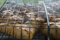 close-up: roast porkmeat inside grill on fire with smoke