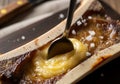 Close-up of roasted bone marrow canoe with spoon and sea salt Royalty Free Stock Photo