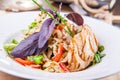 Close up roasted chicken salad with greenery and vegetables on the white plate. Selective focus, copy space Royalty Free Stock Photo