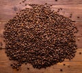 Close-up roasted coffee beans on brown wooden background, top view, copy space Royalty Free Stock Photo