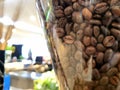 Close-up of roasted coffee beans inside a transparent coffee machine hopper Royalty Free Stock Photo
