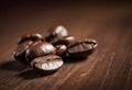 Close-up of roasted coffee beans on a wooden surface