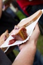 Close-up of a roasted meat on a paper plate with bread