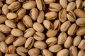 Close-up of roasted and salted cracked pistachios on a wooden table