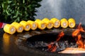 Close-up of barbecued sweet corn over dark background