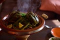 Close-up roasted vegetables in clay pot tagine with stem. Extreme closeup photography for food blogs and advertisings