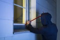 Robber Using The Crowbar To Open The Glass Window Royalty Free Stock Photo