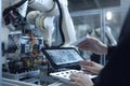 Close up of robot arm and factory worker using digital tablet. Technology and industrial concept. An engineer rearview and hands Royalty Free Stock Photo