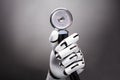 Close-up Of A Robot`s Hand Holding Stethoscope