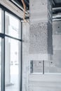 Close-up of a robotic 3D printer arm depositing precise concrete layers for a modern residential building