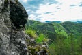 Rein - Close up of rock formation and flower with panoramic view of Grazer Bergland, Prealps East of the Mur Royalty Free Stock Photo