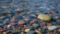 Close up of rocks in shallow water with ripple effect and reflections Royalty Free Stock Photo