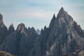 CLOSE UP: Rocky mountain peaks of Tre Cime tower into the clear blue fall skies. Royalty Free Stock Photo