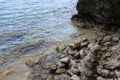 A close up of the rocky shoreline of Lake Michigan with water lapping over the rocks in the summer in Cave Point County Park Royalty Free Stock Photo
