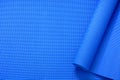 Close up roll blue color yoga mat texture background,top view, copy space, healthy lifestyle, sport and exercise concept Royalty Free Stock Photo