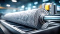 A close-up of a roll of material on a conveyor belt in an industrial setting. Royalty Free Stock Photo