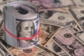 Close Up Roll of One Hundred US Dollar Bills Secured with Red Rubber Band Royalty Free Stock Photo